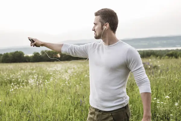 Happy young man in a field — Stock Photo, Image