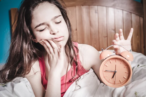 Teen sleepy young girl waking up in bed — Stock Photo, Image