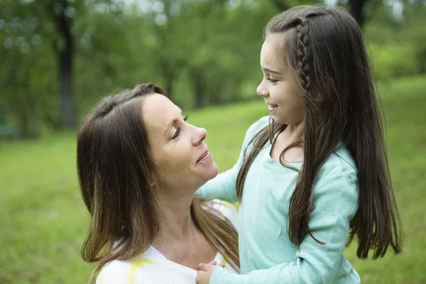 Mother and daughter in forest on a meadow — Stock Photo, Image