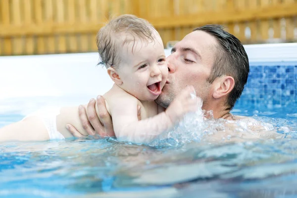 Retrato de jovem família com bebê e criança na piscina — Fotografia de Stock