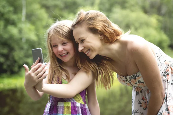 Mother and daughter in forest together — Stock Photo, Image