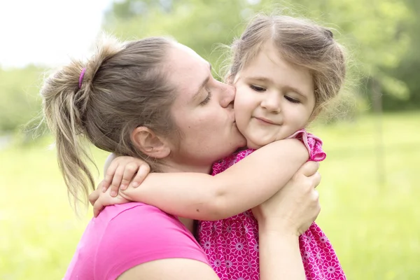 Mother and daughter in forest on a meadow — Stock Photo, Image