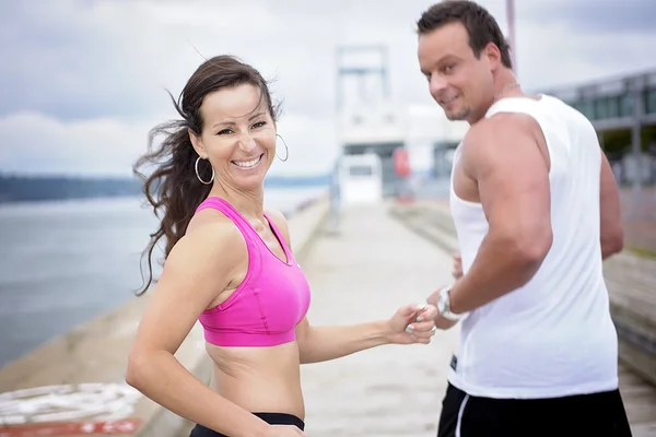 Sport woman and man jogging on road outside. — Stock Photo, Image