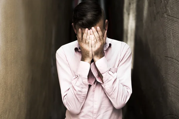 Portrait of young, depressed man in pain — Stock Photo, Image