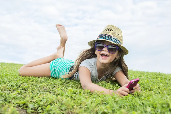 Beautiful portrait of a little girl outside on grass — Stock Photo, Image