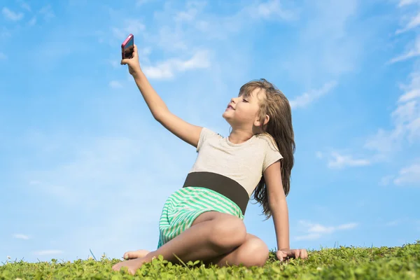 Beautiful portrait of a little girl outside on grass — Stock Photo, Image