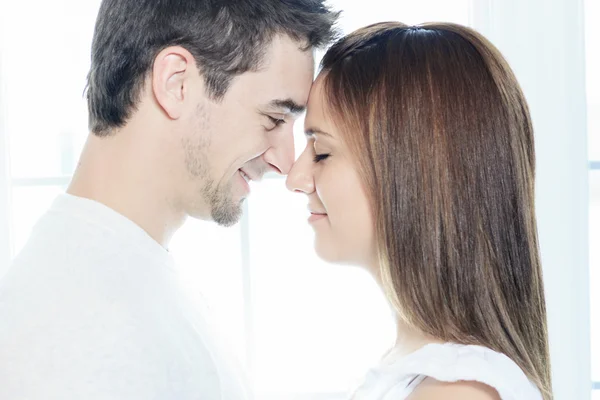 A couple having great time close to the window — Stock Photo, Image