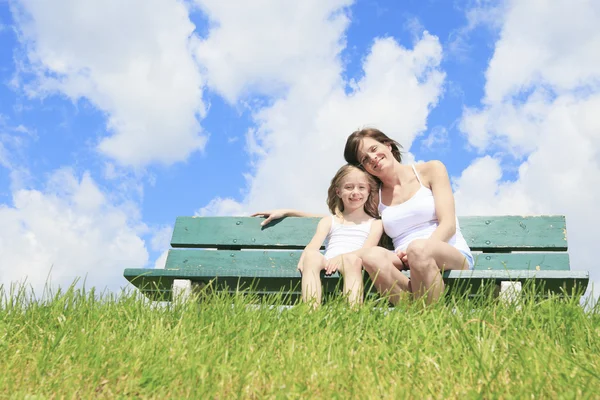 Woman with his child sitting on the bench — Stock Photo, Image