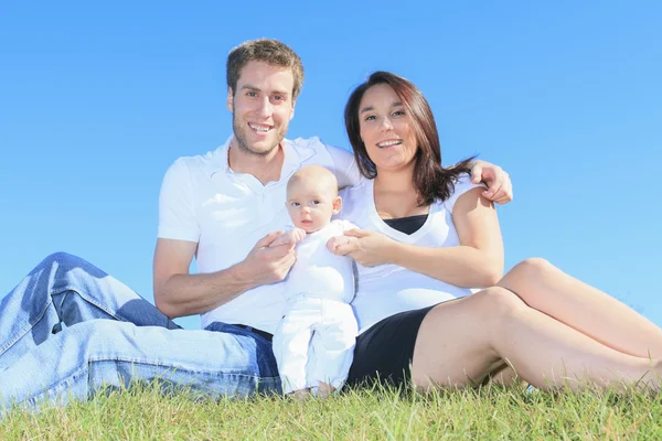 Happy young family with little baby boy outdoors — Stock Photo, Image