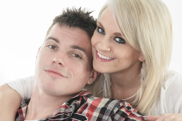 Young beautiful couple on a sofa at home — Stock Photo, Image