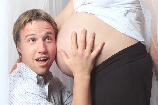 Pregnant woman with his boyfriend on the baby room — Stock Photo, Image