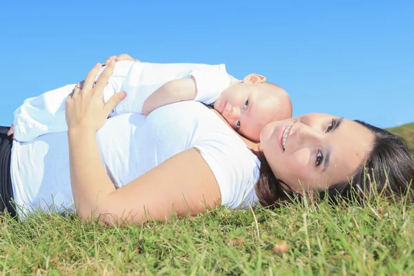 A Happy mother and her little son in the summer field — Stock Photo, Image