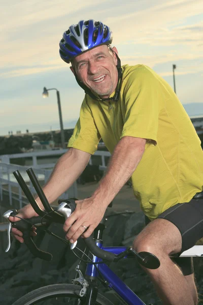 Senior man on bike at the sunset. — Stock Photo, Image