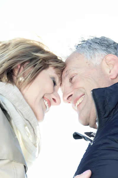 Portrait of happy senior couple in winter season — Stok Foto