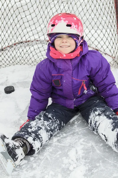 Criança no gelo de hóquei com um disco . — Fotografia de Stock