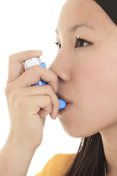 Close up image of a young woman using inhaler for asthma. White — Stock Photo, Image