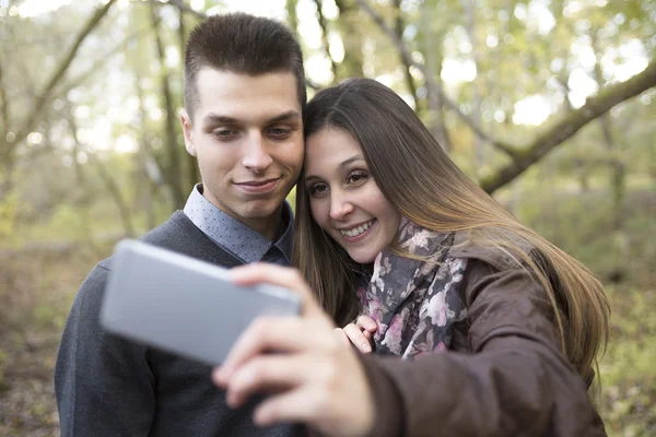 Teen couple at autumn park — Stock Photo, Image