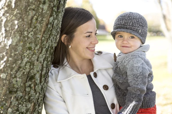 Happy young mother and her son spending time outdoor in the park — Stock Photo, Image