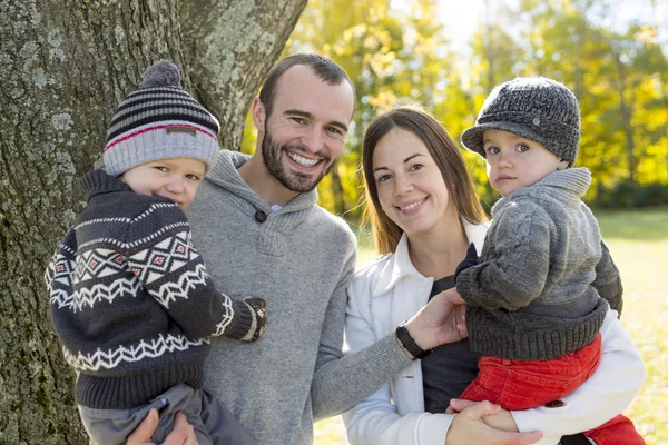 Happy family having fun in autumn park — Stock Photo, Image