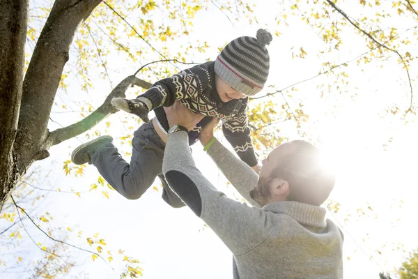 Retrato de pai feliz com filho no parque de outono . — Fotografia de Stock