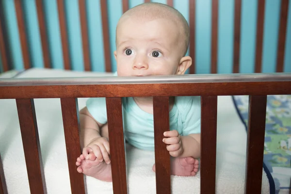 Adorable baby in his crib — Stock Photo, Image