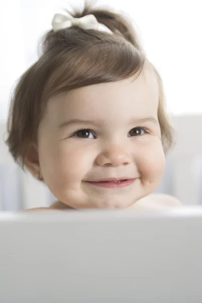 Infant baby resting and playing in his little baby bed — Stock Photo, Image