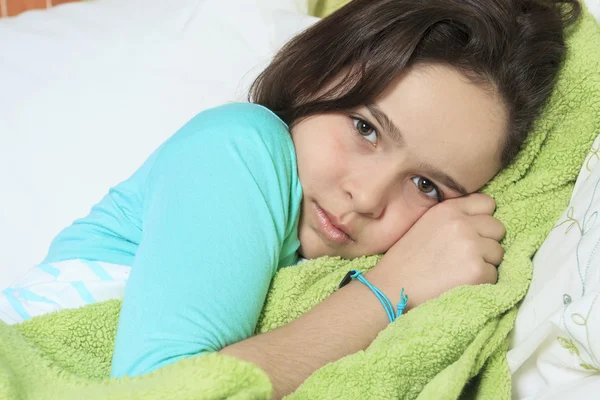 Young sad woman sitting on bed — Stock Photo, Image