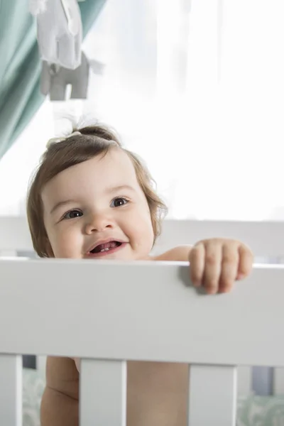 Infant baby resting and playing in his little baby bed — Stock Photo, Image