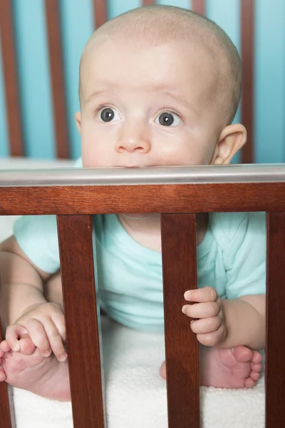 Adorable baby in his crib — Stock Photo, Image