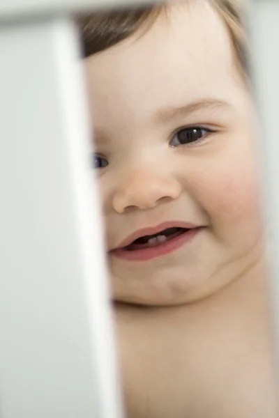 Infant baby resting and playing in his little baby bed — Stock Photo, Image