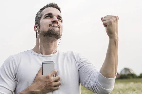 Happy young man in a field — Stock Photo, Image