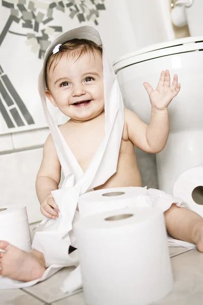 Toddler ripping up toilet paper in bathroom — Stock Photo, Image