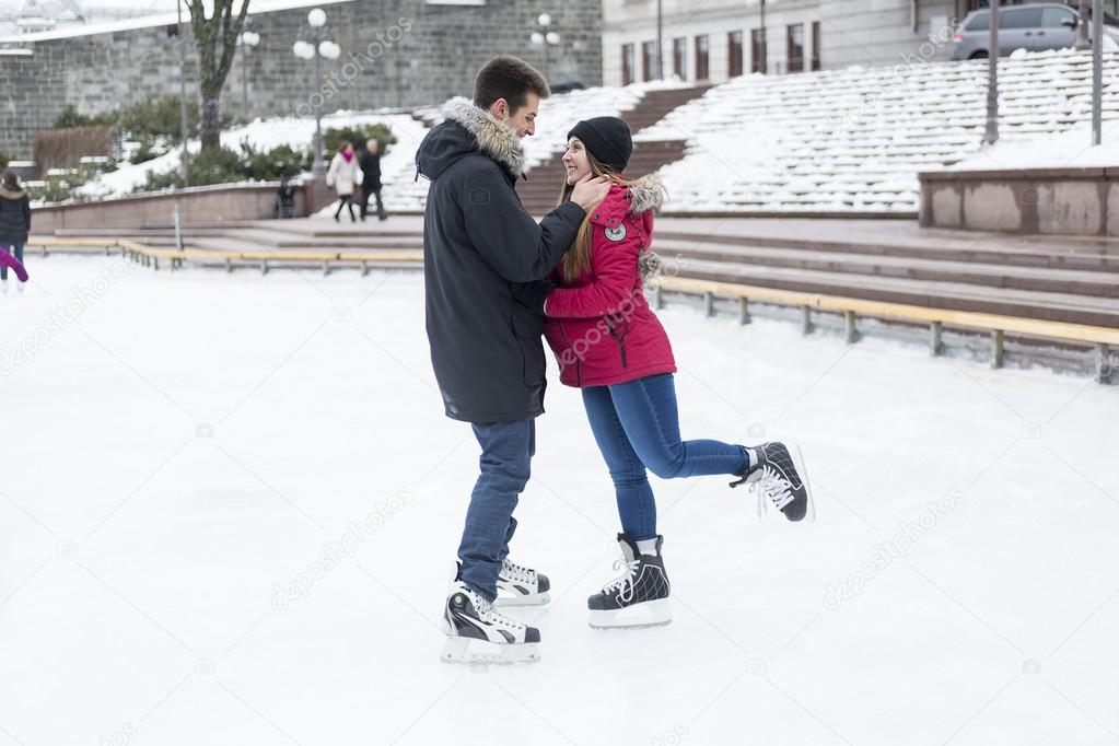Ice skating couple having winter fun on ice skates Quebec, Canada