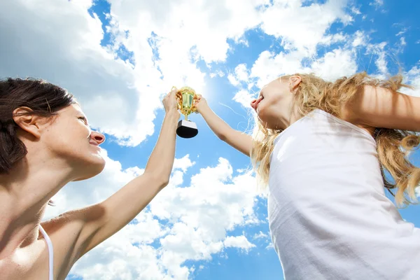 Felice madre e figlia tenendo un trofeo in alto — Foto Stock