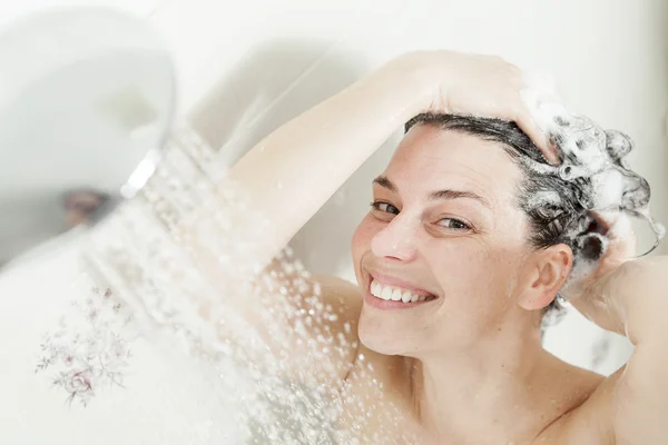 Ducha mujer. Feliz mujer sonriente lavándose el hombro duchándose en —  Fotos de Stock