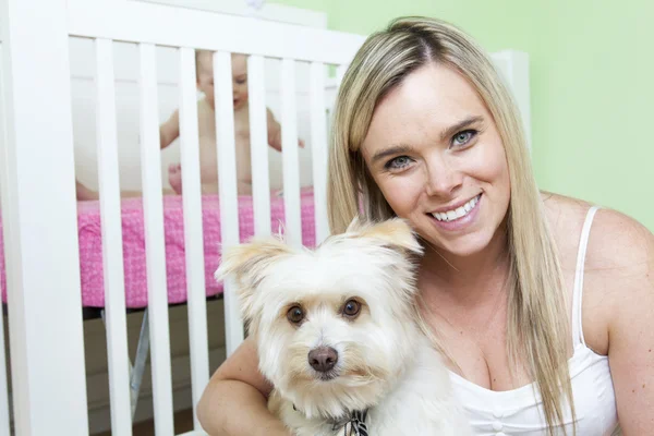 Mother and baby with dog in the baby room — Stock Photo, Image