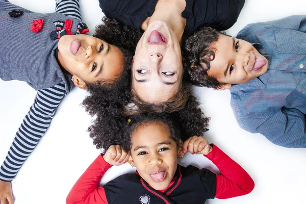 A family lay on the floor of a photography studio — Stock Photo, Image