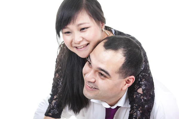 Portrait of smiling couple embracing on white background — Stock Photo, Image