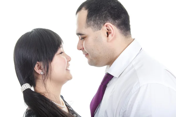 Portrait of smiling couple embracing on white background — Stock Photo, Image