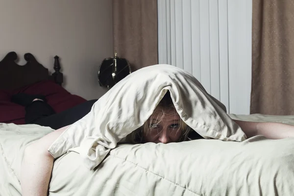 Eine Frau fühlt sich krank, wenn sie im Bett liegt — Stockfoto