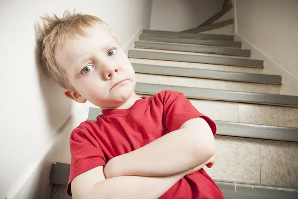 Neglected lonely child leaning at the wall Royalty Free Stock Images