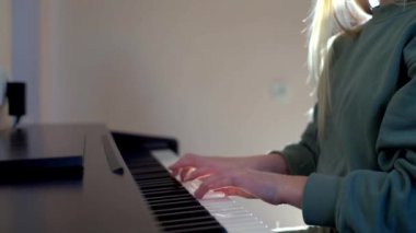 Evde piyano çalan bir kız.