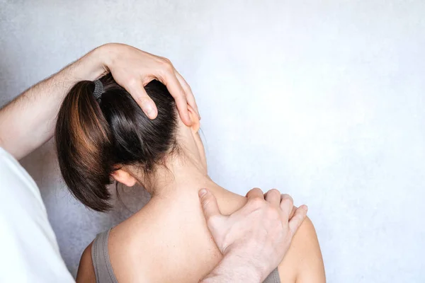 A woman having chiropractic neck adjustment. Osteopathy, kinesiology, bad posture correction