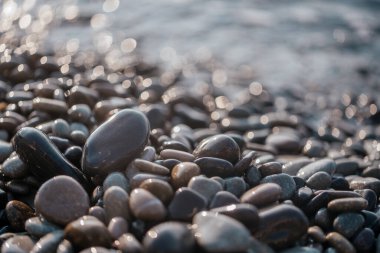Kıvılcım saçan çakıl taşları, köpüklü deniz dalgaları.