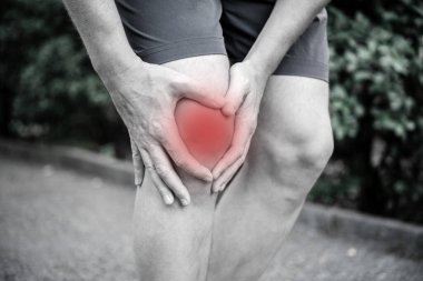 A man having inflammation and swelling in his knee, common knee trauma injury, tendinitis clipart