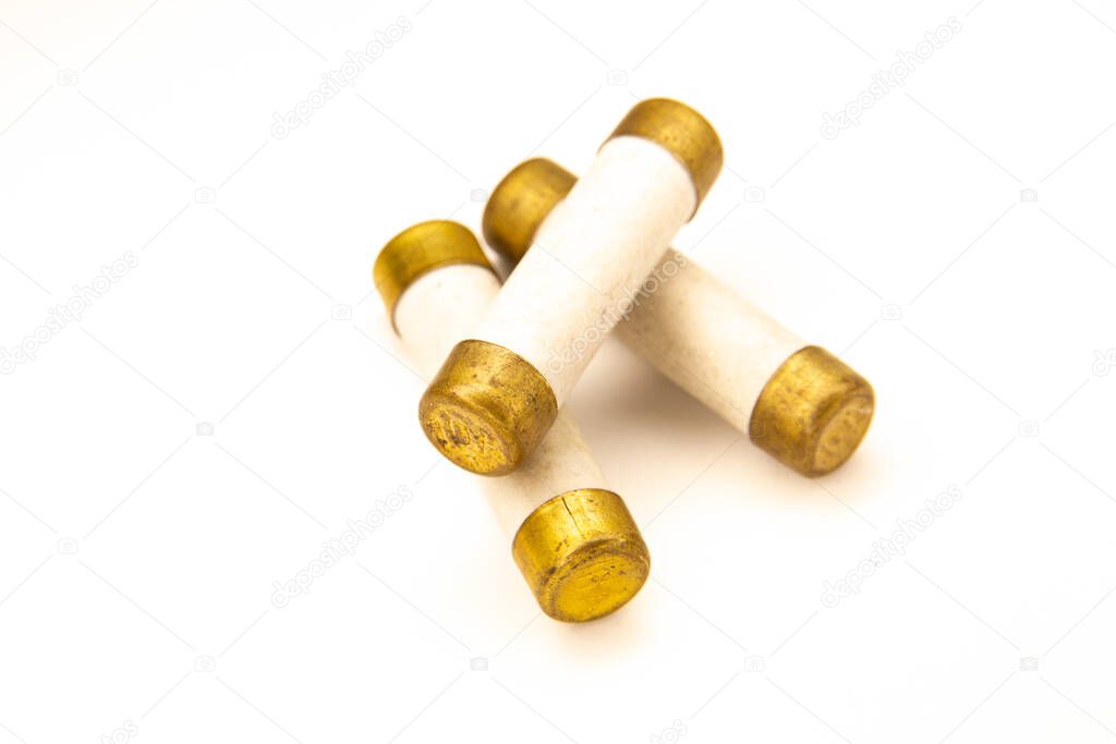 Old electric high-voltage fuses on a white background.