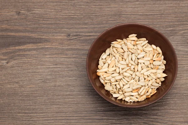 A ceramic bowl full of Seeds over old wood background — Stock Photo, Image