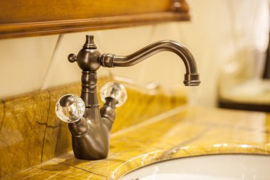 Closeup of water-supply faucet isolated in modern bathroom clipart