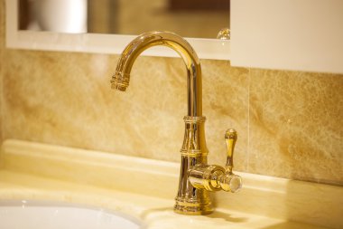 Closeup of water-supply faucet isolated in modern bathroom clipart
