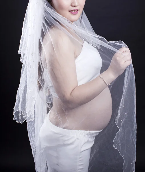 A pregnant mother in black background — Stock Photo, Image